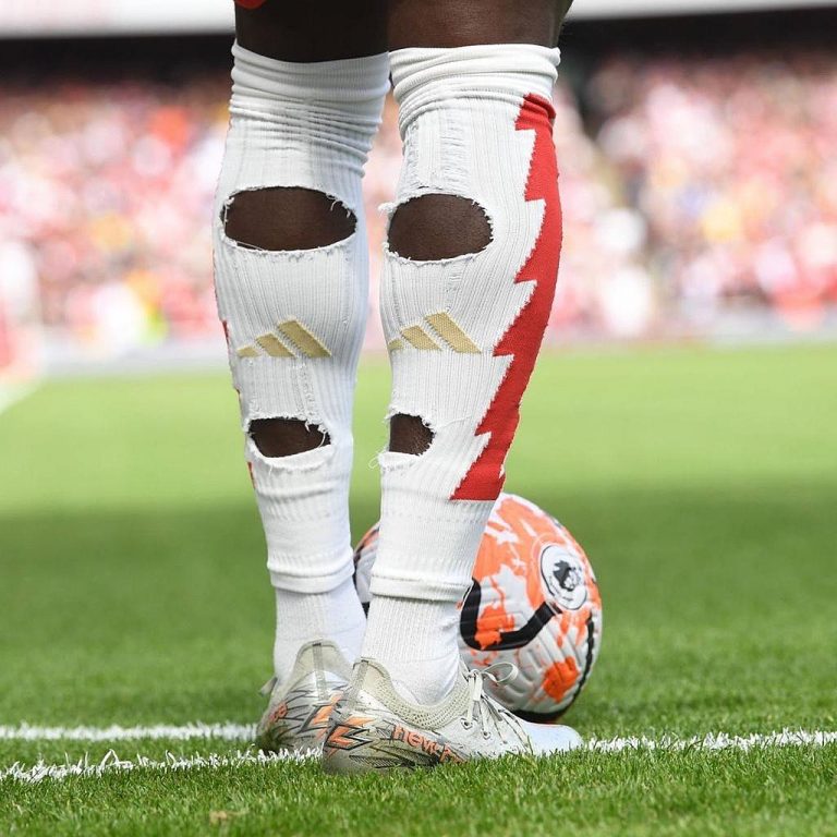 Why footballers cut holes in their socks